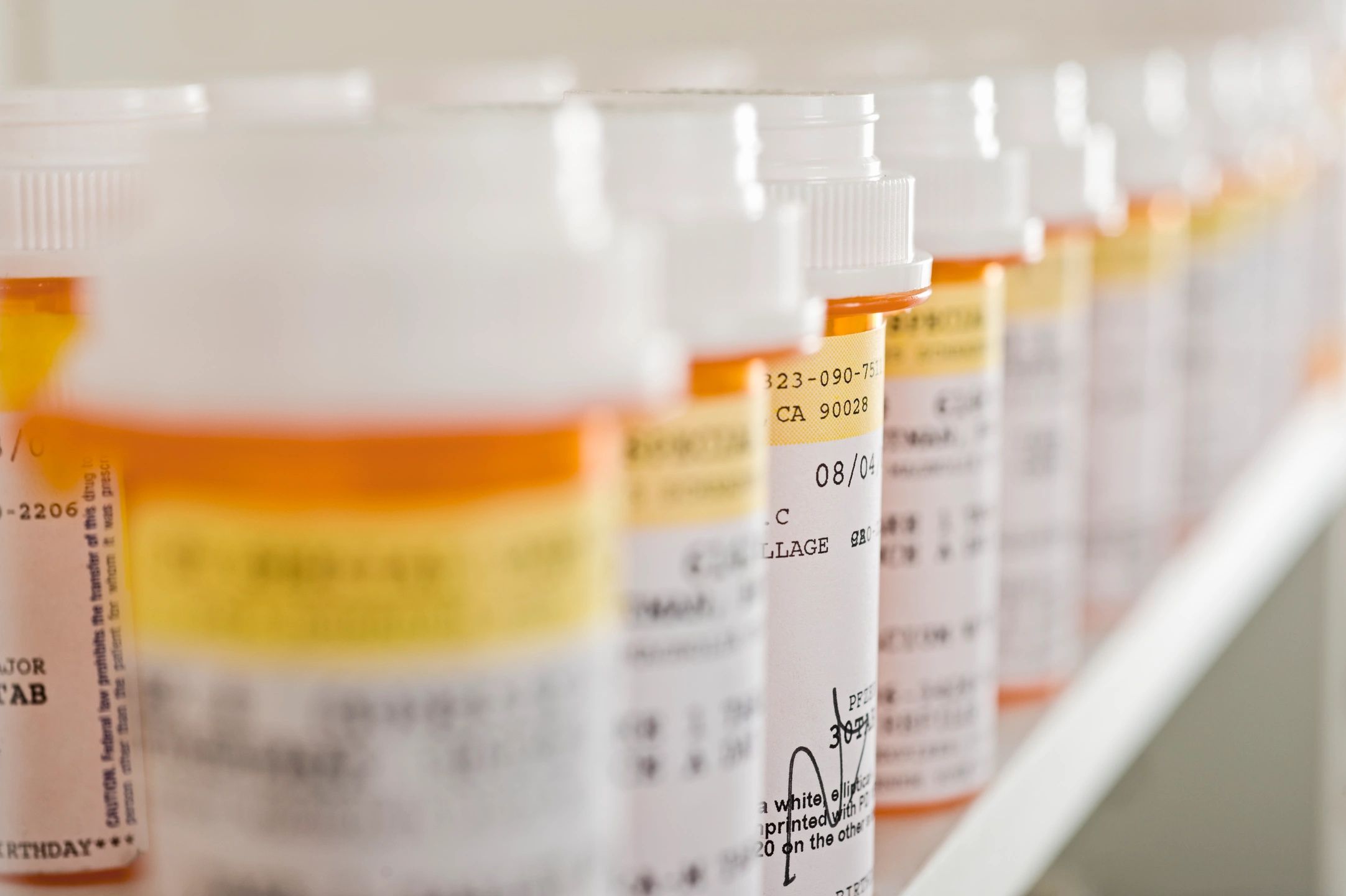 close up of a line of prescription pill bottles